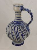 An Antique German Stone Ware Pottery Ale Jug with decorative blue floral design with pie crust