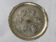 An Indo-Chinese Silver Dish, with raised figures in various poses, approx 25 cms