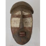 A South Eastern Congo, Lwalwa Mask, polychrome kaolin decoration, the mask with elongated