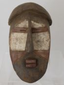 A South Eastern Congo, Lwalwa Mask, polychrome kaolin decoration, the mask with elongated