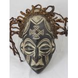 A Central African (Congo/Angola)Tchokwe Mask, represents an ancestral female with mono chrome