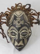 A Central African (Congo/Angola)Tchokwe Mask, represents an ancestral female with mono chrome