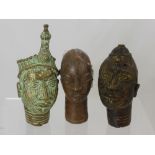 Two West African Benin Bronze Heads, together with a copper example approx 13.5 cms and 19 cms (3)