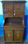 An Edwardian Mahogany Cabinet, with swept supports and two cupboards above and two beneath,