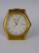 A Christian Dior Travel Alarm Clock, the clock having a gilt finish with date aperture, case nr
