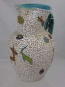 An Italian 'Deruta' Ceramic Water Jug, naive in style, handle painted with animals, approx 23 cms