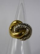 A Lady's 18ct Yellow and White Gold 'Knot Ring', mm CPJ, size K, approx 8.6 gms