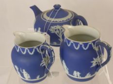 Cobalt Wedgwood Jasperware, including a teapot, two jugs, pot pourri jar and a jam jar.