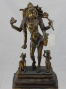 A Brass Indian Deity, depicted standing with a water bearer and sacred cow to either side of a lotus