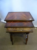 A Nest of Mahogany Tables, with cross banded supports and turned stretcher, approx  57 x 41 x 59