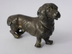 A Cast Metal Figurine of a Dachshund, together with a figurine of a Border Collie.(2)