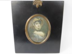 An Antique Portrait Miniature, painted on ivory, depicting a young woman, in an ebonized frame,