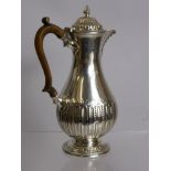 An Antique Solid Silver Chocolate Pot, the pot having frame finial with ribbed and beaded lid
