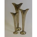 Three Silver Metal Graduated Stem Vases for a centre piece together with a candle stick.