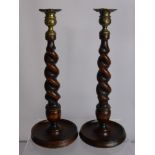 A Pair of Oak Barley Twist Candle Sticks, with decorative brass mounts.