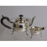A Solid Silver Bachelor Tea Pot, Birmingham hallmark dd 1919, mm W A together with a sugar bowl