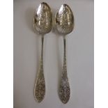 A Pair of Silver Hand Engraved Serving Spoons, having floral decoration to bowl and pierced floral