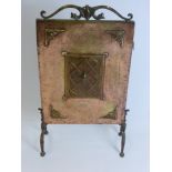 An Arts & Crafts Style Fire Screen in hammered copper and brass, approx 68 x 36 cms.