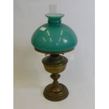 A Victorian Brass Oil Lamp, with green shade and original glass funnel.