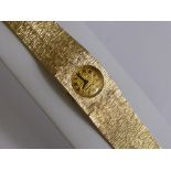 A Lady's 9 Ct Gold Vintage  Beuche Girod Wrist Watch, the watch having a 9 ct bark finish integral