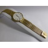 A Gentleman's 9 Ct Yellow Gold Longines Quartz Wrist Watch. The watch having a white face with Roman