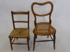 An Antique Balloon Back Bedroom Chair, cane seat with turned stretchers and splayed legs, together