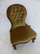 A Mahogany Button Back Nursing Chair, on cabriole legs with casters.