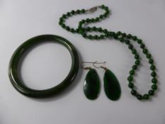 A Green Spinach Jade Bangle, Earrings and Beaded Necklace, necklace approx 49 cms. (3)