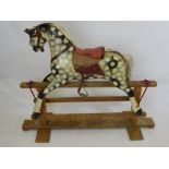 A Vintage Dappled Grey Rocking Horse, with saddle, bridle and horse hair mane and tail.