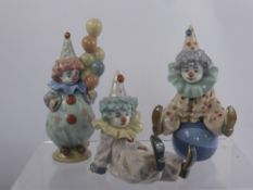 A Trio of Lladro Figurines entitled "Having a Ball" No. 05813, "Littlest Clown" No. 05811 and "Tired