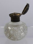 A Victorian Silver Topped Cut Glass Perfume Bottle, London hallmark dd 1883, with the original glass