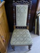 An Antique Oak Hall Chair, decorative carving to chair frame with turned legs on casters.