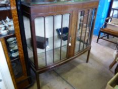 An Edwardian Leslie Belcher (Art House Furniture), glazed bow fronted display cabinet, two glass