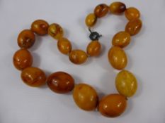 A Set of Antique Hand Carved Natural Amber Beads, the butterscotch opaque, egg yolk coloured