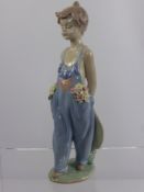 A Lladro Society Porcelain Figurine entitled "Pocketful of Wishes", No. 07650 dd 1997 approx 22