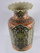 A Moroccan/Persian Vase, with fluted rim, iron red ground with cream, yellow, cobalt scrollwork