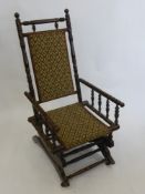A Vintage American Rocking Armchair, upholstered in floral fabric.