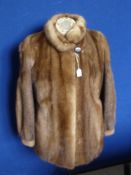 A Lady's Saga 3/4 Length Mink Coat, label to inside, size medium.