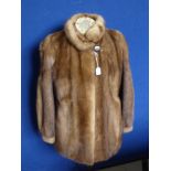 A Lady's Saga 3/4 Length Mink Coat, label to inside, size medium.