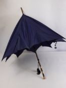 A Lady's Vintage 9 Ct Rose Gold and Bamboo Parasol, the parasol having 9 ct gold end and bands.