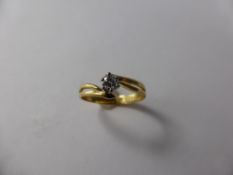 A Lady's 18 Ct Yellow and White Gold Diamond Solitaire Ring, dia 15 pt, size M, approx 2 gms.