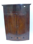 A Georgian Mahogany Corner Cupboard, with three drawers (two dummy) and three internal shelves,