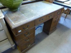 An Oak Pedestal Office Desk, with green tooled leather top (Grecian key design), three drawers to