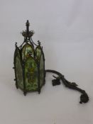 A Victorian 'Gothic' Hall Lantern, with decorative green panels and a wrought iron arm support.