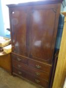 A Mahogany Wardrobe, with two short and two long drawers, brass swan neck handles, supported on