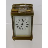 A French Brass Carriage Clock, with enamel face and Roman dial, approx 10 cms