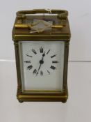 A French Brass Carriage Clock, with enamel face and Roman dial, approx 10 cms