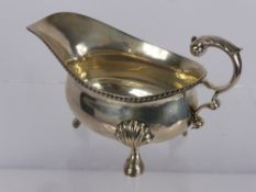 A Silver Gravy Boat, London hallmark, dd 1939, mm E.B. Ss the boat supported on three hoof feet,