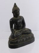 An Antique Cast Metal Figure of a seated Buddha, approx 18 cms high.