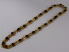 An Antique Asian 9/10 Ct Gold and Gilded Garnet Necklace, the necklace set with 24 garnets, approx